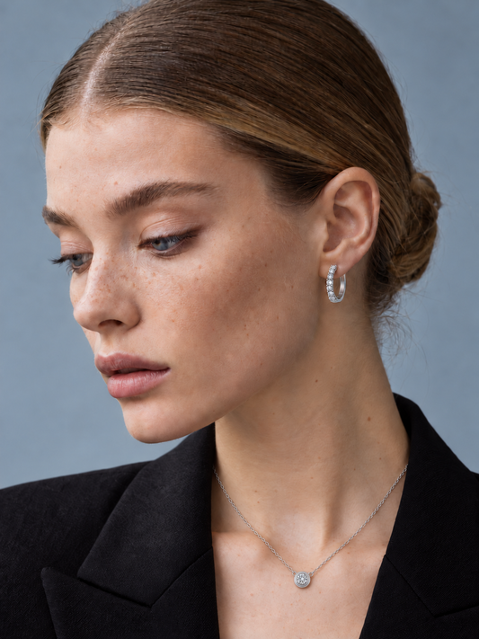 Mara wearing the silver Isabella 0.5ct moissanite bubble pendant necklace, styled with Solana hoop earrings