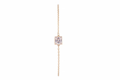 A delicate yellow gold chain bracelet featuring a square bezel-set clear gemstone pendant.