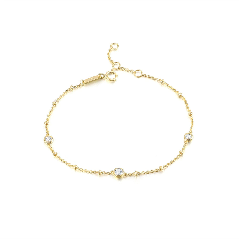 Nyla gold bubble bracelet with three round bezel-set moissanite stones and adjustable clasp