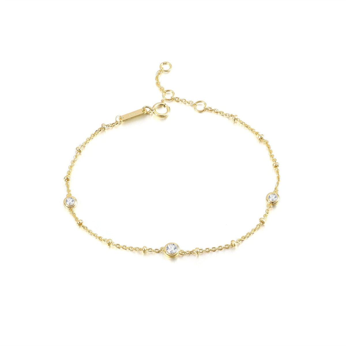 Nyla gold bubble bracelet with three round bezel-set moissanite stones and adjustable clasp