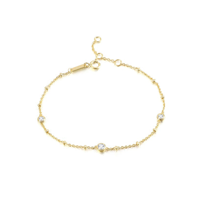 Nyla gold bubble bracelet with three round bezel-set moissanite stones and adjustable clasp